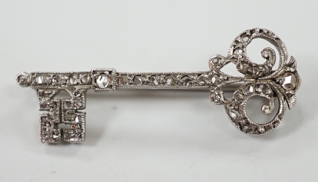 An early 20th century white metal and rose cut diamond set 'key of the door' brooch, 33mm, gross weight 2.1 grams.